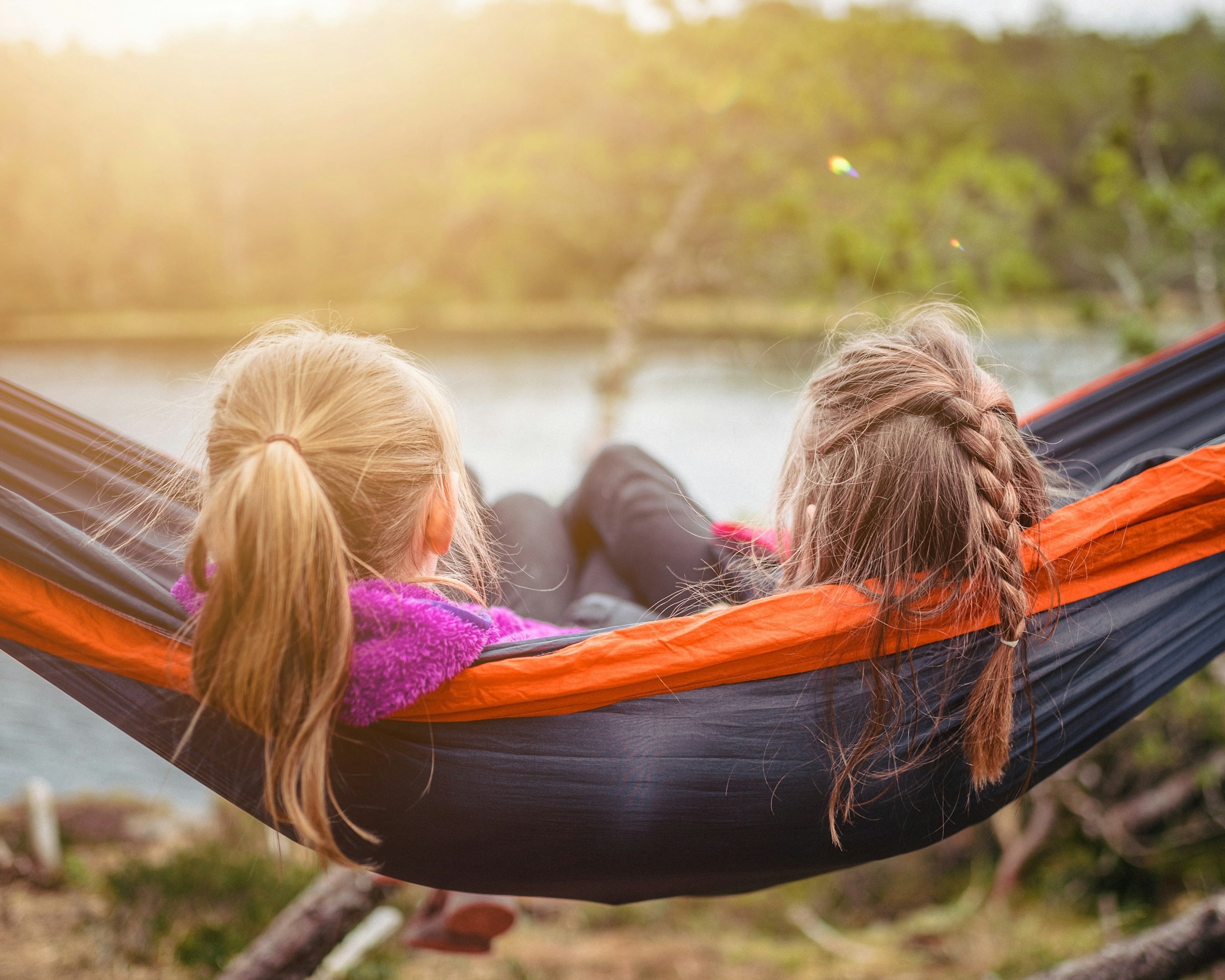 Campers relaxing in a hammock, representing calm and control.